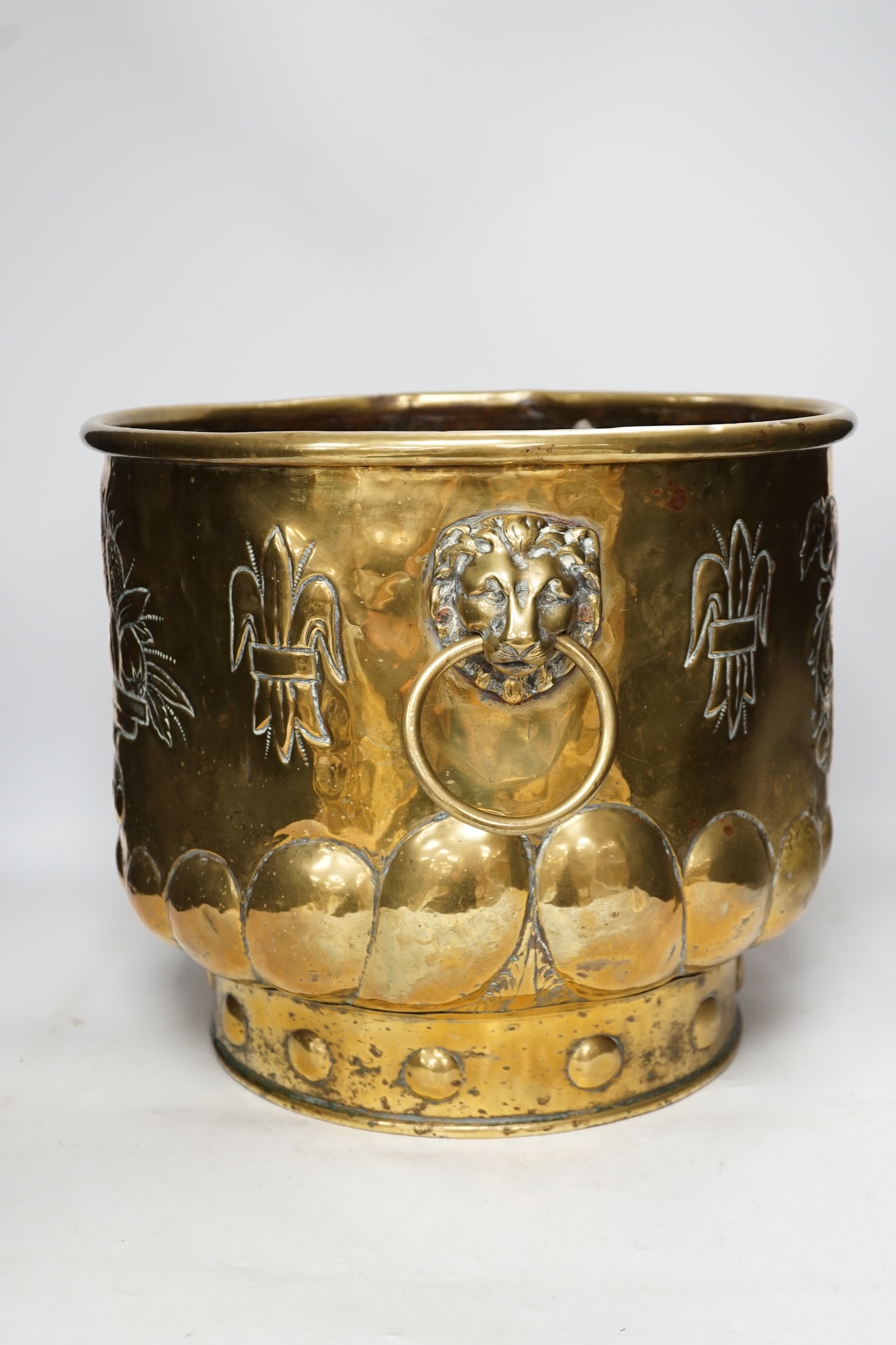 A 19th century Dutch embossed brass log basket, 33cm. Condition - poor, not original base